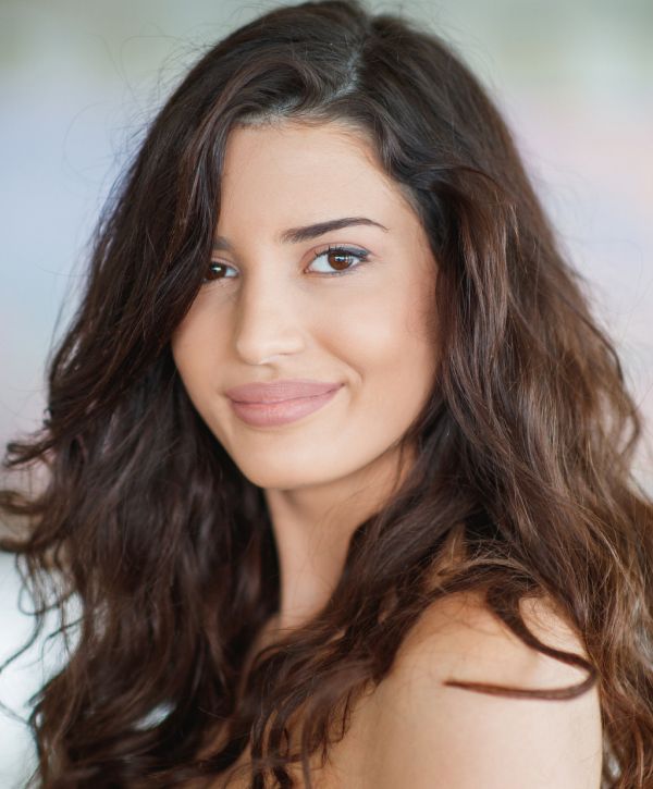 xeomin patient model with curly brown hair smiling