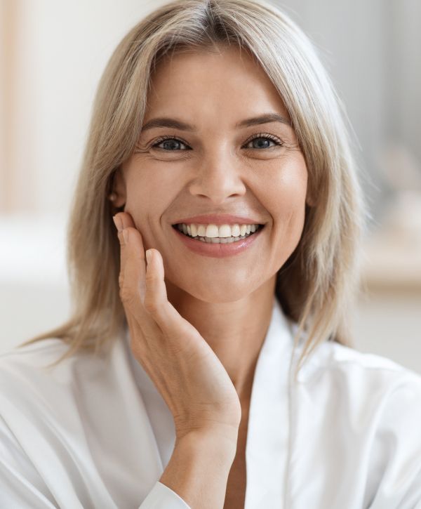 madison dental implant patient model smiling broadly while touching her cheek